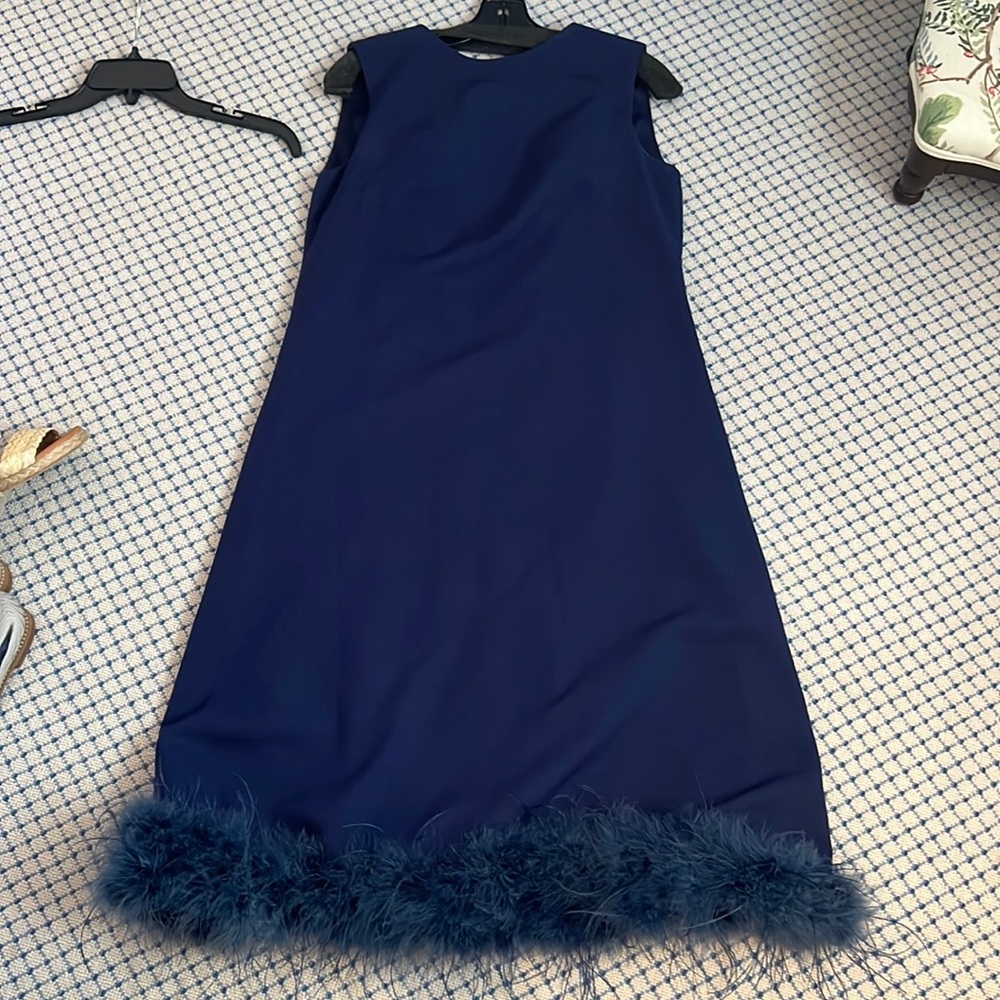 Navy blue occasion dress with feather trim at bottom